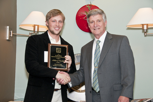 A.J. Eiserloh receives Endowment Scholarship from Dr. Bill Williams.