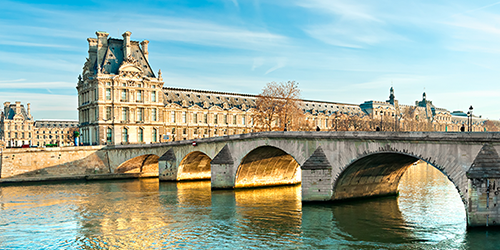 Building with bridge over water in France.