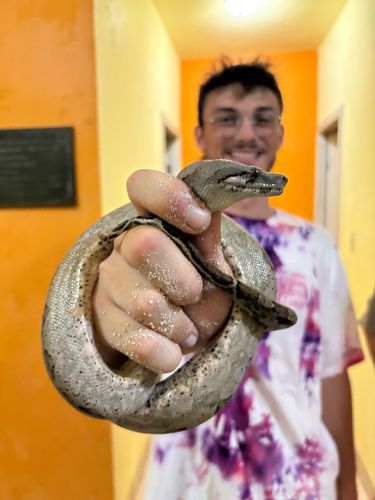 Student holding a snake in Belize