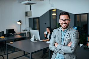 Man smiling in front woman working on computer at table.