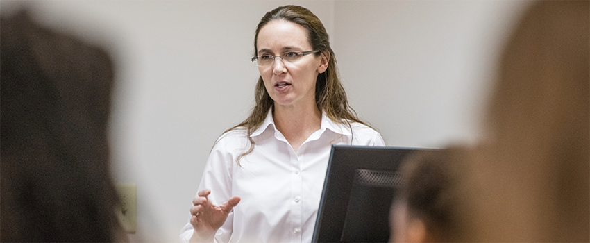 Dr. Forrester teaching in front of class