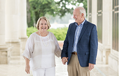 Man and woman holding hands on South's campus.