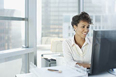 Woman working at computer typing