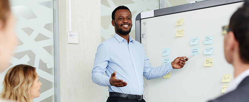 Teacher at white board presenting.