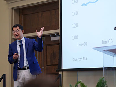 Real Estate professional presenting on stage.