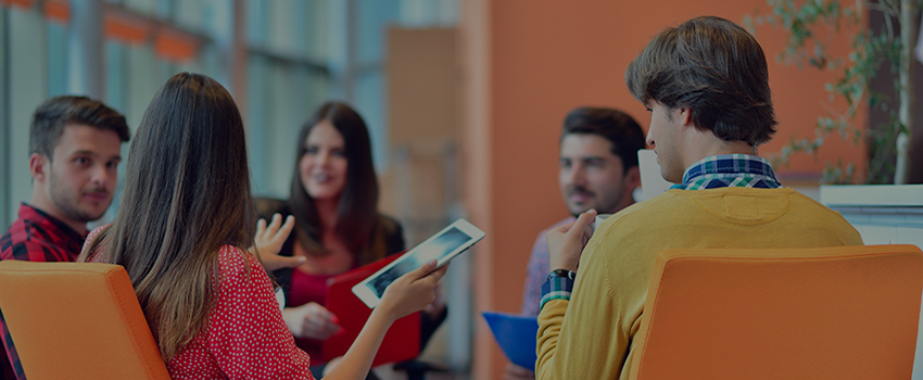 Group of people sitting in circle talking.