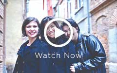 Three girls smiling with black jackets on