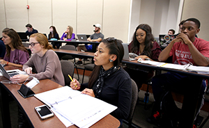 Students sitting at tables in class.