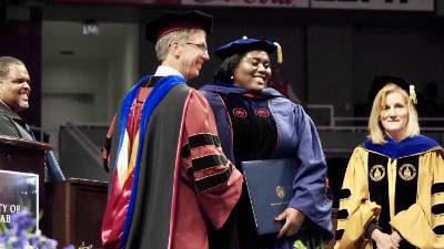 Dr. Lucas receiving her diploma