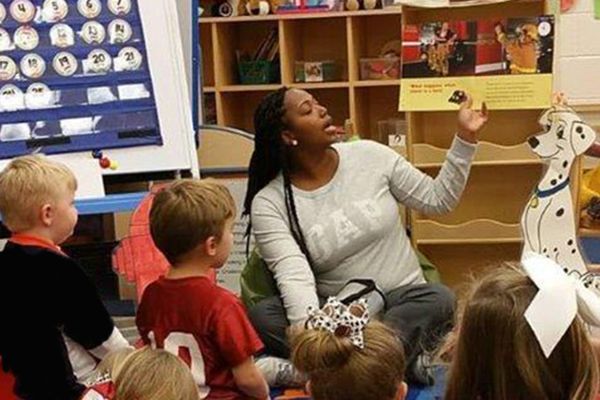 Student Teacher reading to students in classroom.