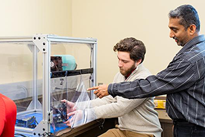 Electrical Engineering student working with professor on project.