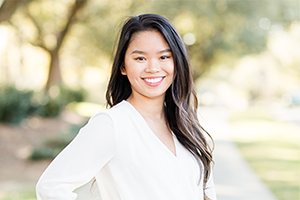 Business student outside smiling.