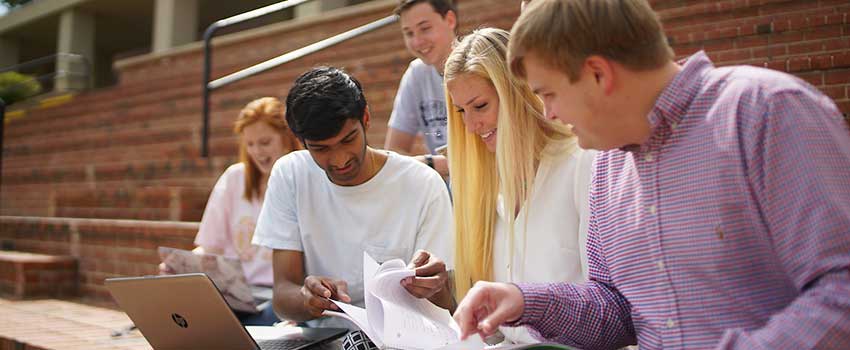 A group of students studying outside.