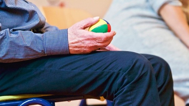 Person squeezing a ball with hand.