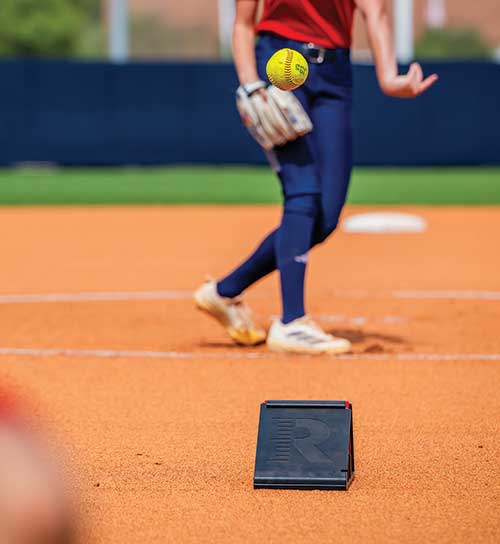 Softball player with Trackman monitor.