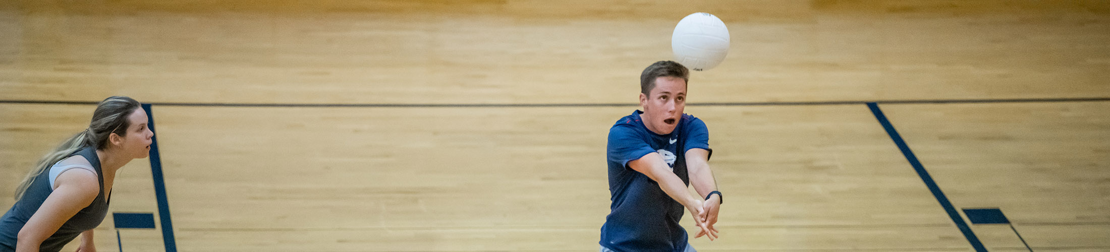 Students playing volleyball in rec center