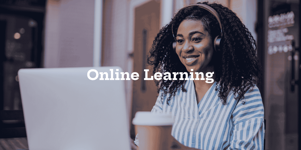 A girl looking at her laptop with headphones on, while smiling