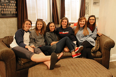 Female sorority women sitting inside chapter house