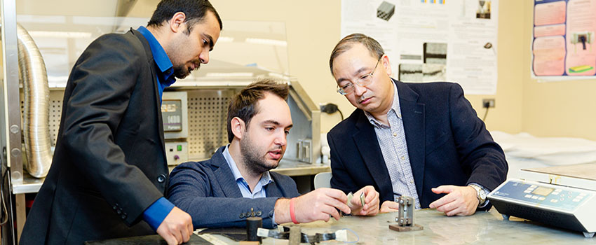 Engineering students working in lab with faculty