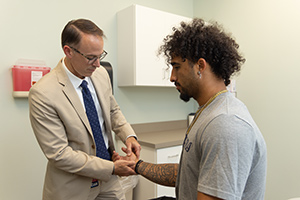 USA Health Sports Medicine doctor working with athlete.