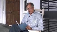 Frye Gaillard reading on the porch